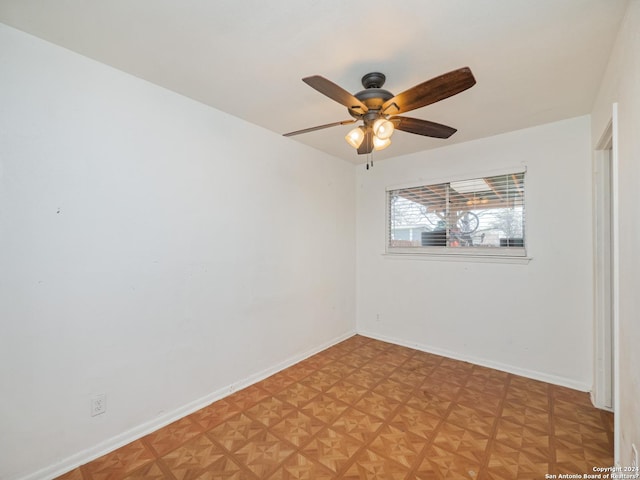 empty room featuring ceiling fan and light parquet flooring