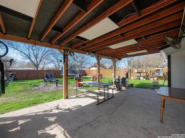 surrounding community featuring a yard, a trampoline, and a patio