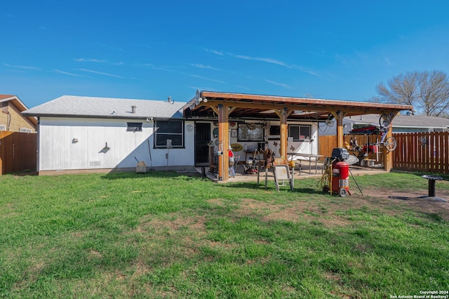 back of house with a lawn