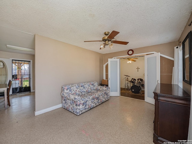 sitting room with a textured ceiling, ceiling fan, and french doors