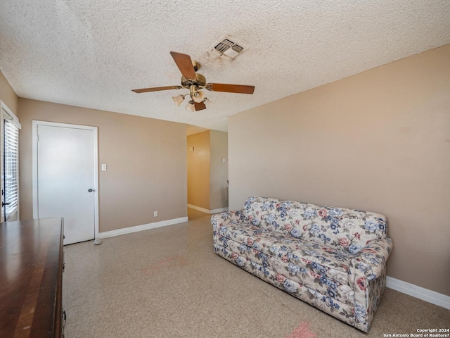 sitting room featuring a textured ceiling and ceiling fan