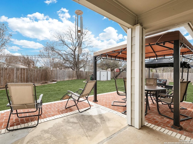 view of patio / terrace with a storage unit and a gazebo