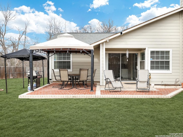 back of house with a yard, a patio, and a gazebo