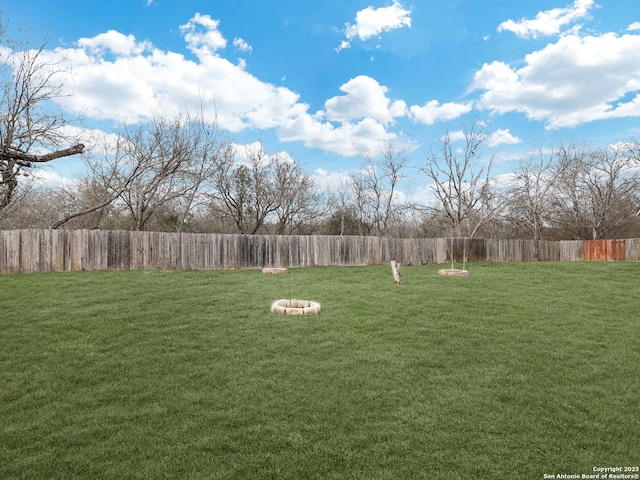 view of yard with an outdoor fire pit