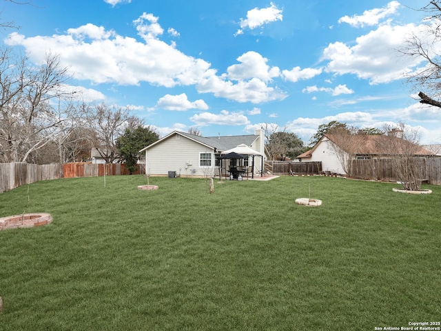 view of yard featuring an outdoor fire pit and a gazebo