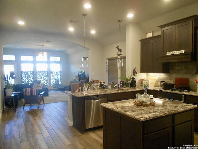 kitchen featuring stainless steel appliances, a center island, light hardwood / wood-style flooring, dark brown cabinetry, and pendant lighting