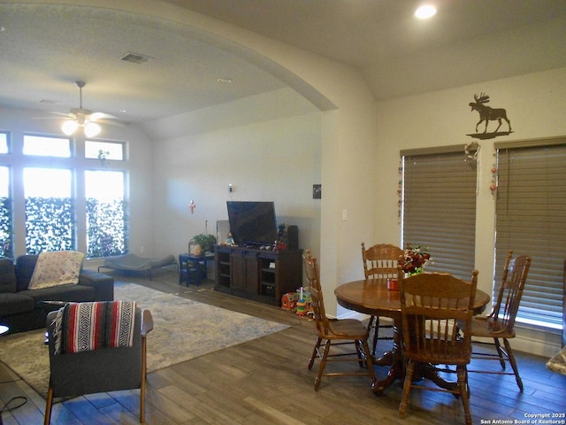 dining area featuring ceiling fan, hardwood / wood-style floors, and vaulted ceiling