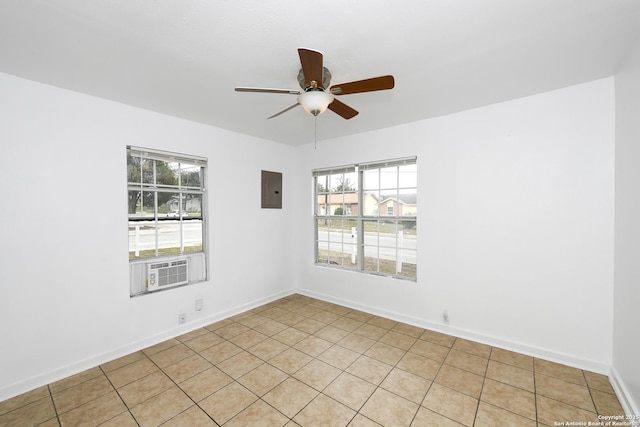 tiled spare room featuring ceiling fan and electric panel