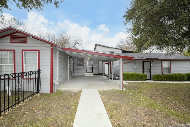 view of front of property with a front yard and a carport