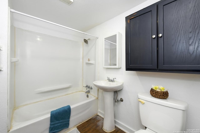 bathroom featuring hardwood / wood-style floors, shower / bathing tub combination, and toilet