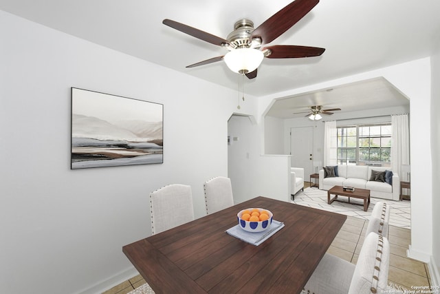 dining area featuring ceiling fan and light tile patterned floors