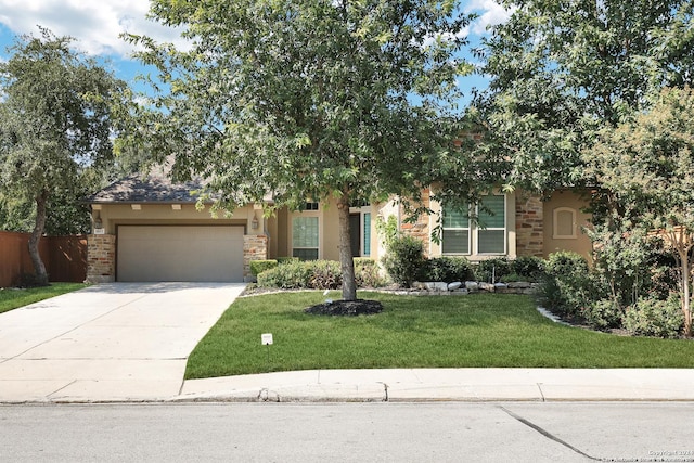 view of property hidden behind natural elements featuring a front yard and a garage