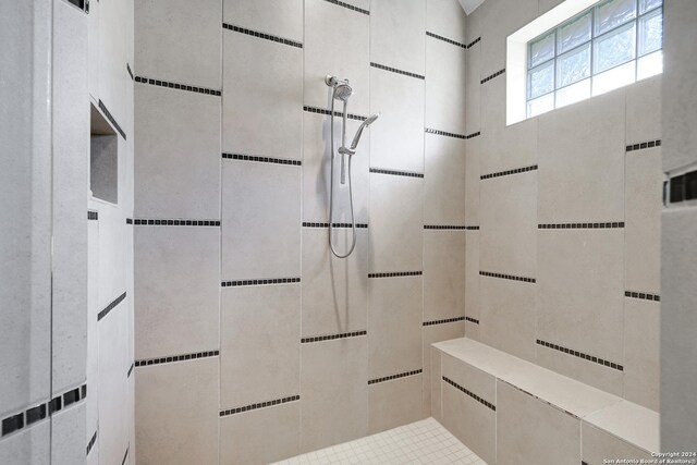 bathroom with tiled shower