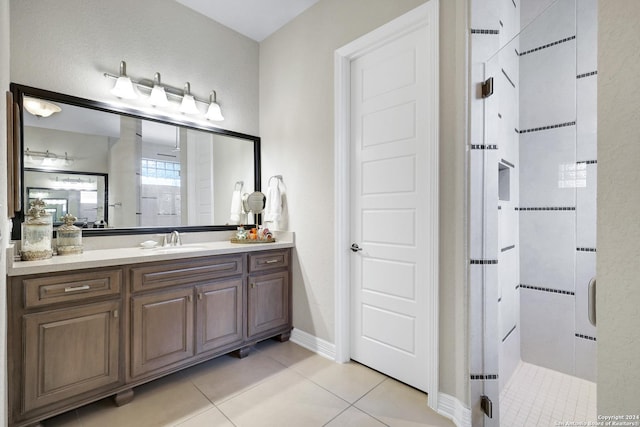 bathroom featuring an enclosed shower, tile patterned flooring, and vanity