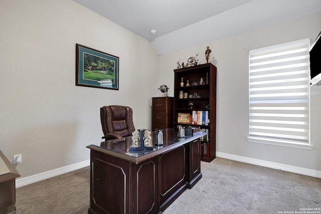 office area featuring light colored carpet and vaulted ceiling