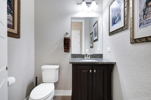 bathroom featuring toilet and vanity