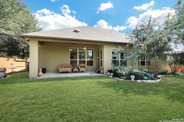 rear view of house with a yard and a patio