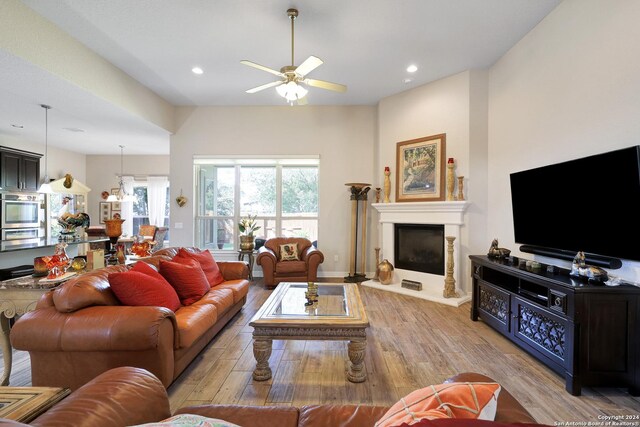 living room featuring ceiling fan and light hardwood / wood-style floors