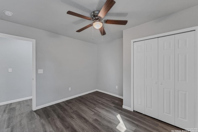 unfurnished bedroom with a closet, ceiling fan, and dark wood-type flooring