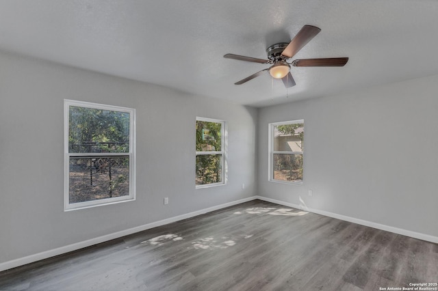 empty room featuring ceiling fan and hardwood / wood-style floors