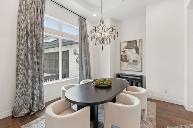 dining space featuring an inviting chandelier and dark hardwood / wood-style floors