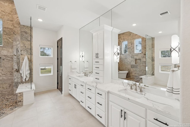 bathroom with vanity and tiled shower