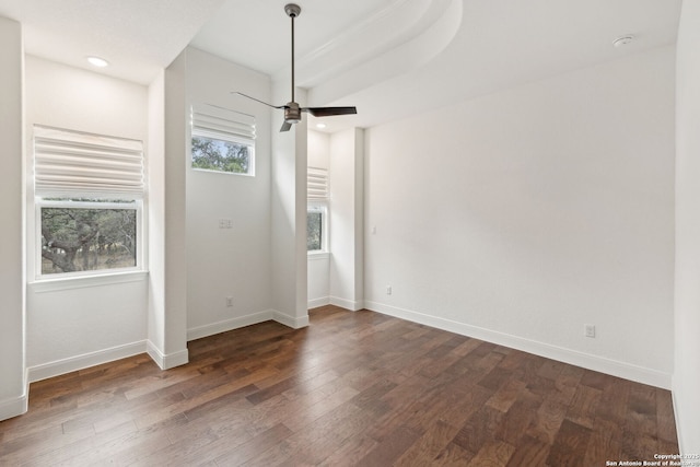 unfurnished room featuring dark hardwood / wood-style flooring and ceiling fan