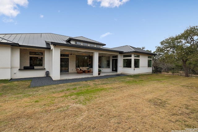 back of property featuring a lawn and a patio