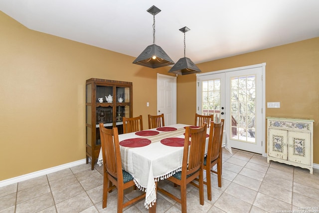 dining area with french doors and light tile patterned flooring