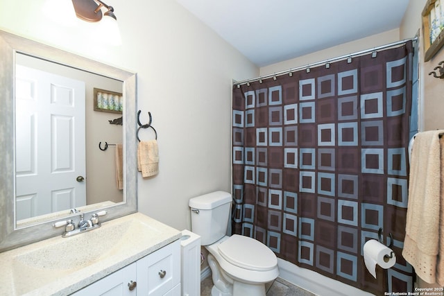 bathroom featuring vanity, toilet, and a shower with shower curtain