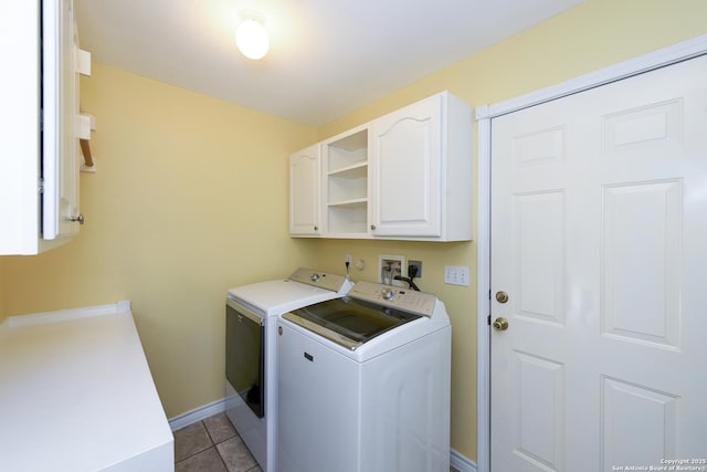 washroom featuring cabinets, independent washer and dryer, and light tile patterned floors