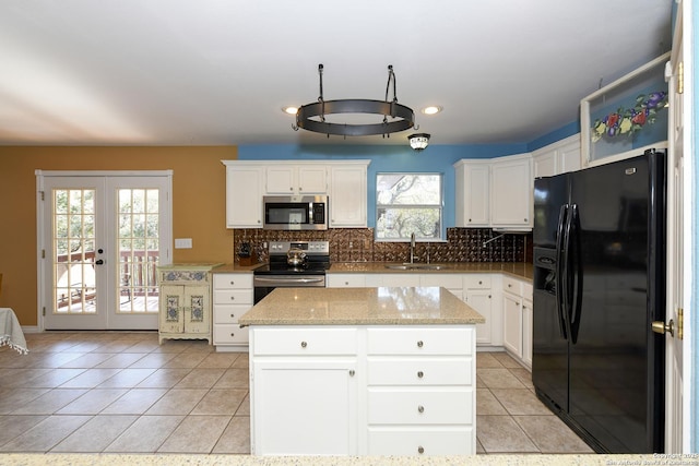 kitchen featuring a kitchen island, white cabinetry, appliances with stainless steel finishes, and sink