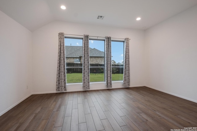 spare room featuring vaulted ceiling