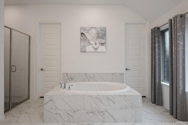 bathroom featuring independent shower and bath and lofted ceiling