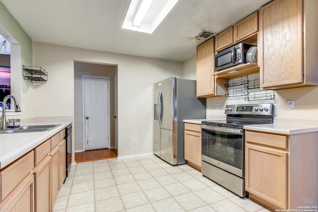 kitchen with sink, light brown cabinetry, and appliances with stainless steel finishes