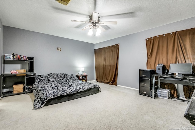 carpeted bedroom with a textured ceiling and ceiling fan