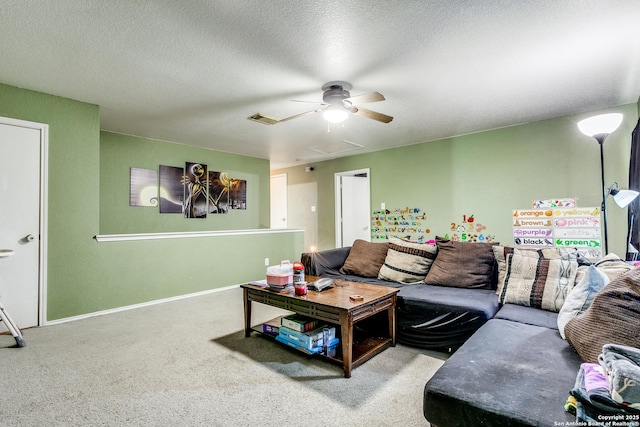 carpeted living room with a textured ceiling and ceiling fan