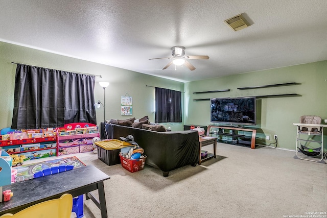 carpeted living room featuring a textured ceiling and ceiling fan