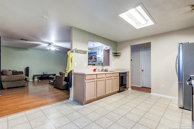 kitchen featuring sink, light brown cabinets, ceiling fan, and stainless steel fridge