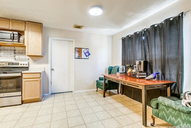 kitchen featuring stainless steel appliances and light brown cabinets