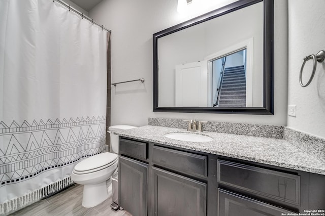 bathroom featuring toilet, vanity, and baseboard heating