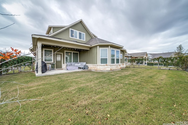 back of property featuring a patio area and a yard