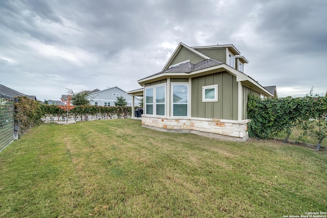 back of house with a lawn