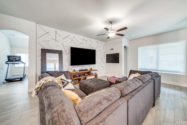 living room with light hardwood / wood-style floors and ceiling fan