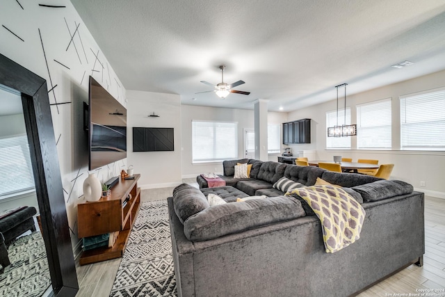 living room with ceiling fan and a wealth of natural light