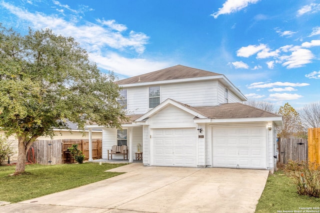 view of property featuring a front yard and a garage