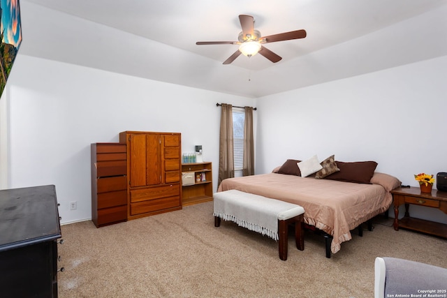 bedroom featuring light carpet and ceiling fan