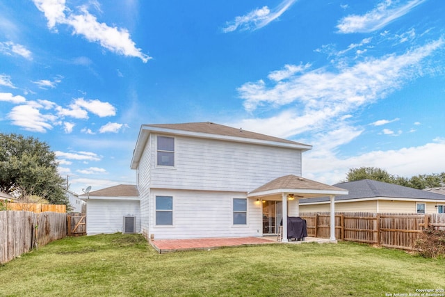 back of house featuring a yard, central AC unit, and a patio