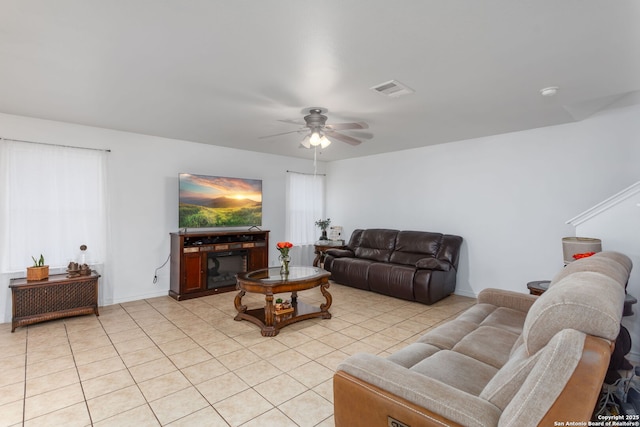 tiled living room featuring ceiling fan