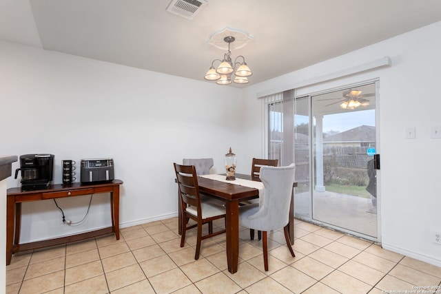 dining room with ceiling fan with notable chandelier and light tile patterned flooring